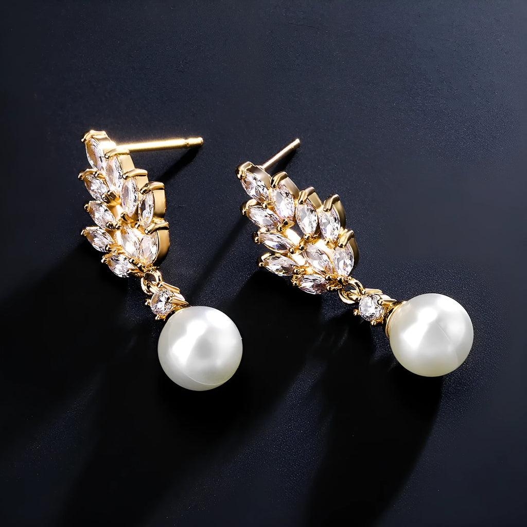 Geometric earrings with white floral micro inlay on a gold, rose gold, or platinum plated background.