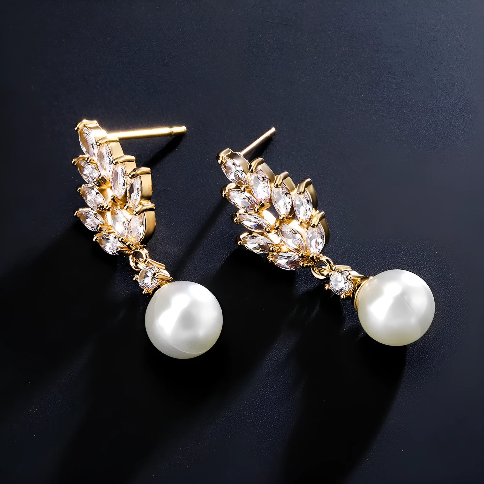Geometric earrings with white floral micro inlay on a gold, rose gold, or platinum plated background.