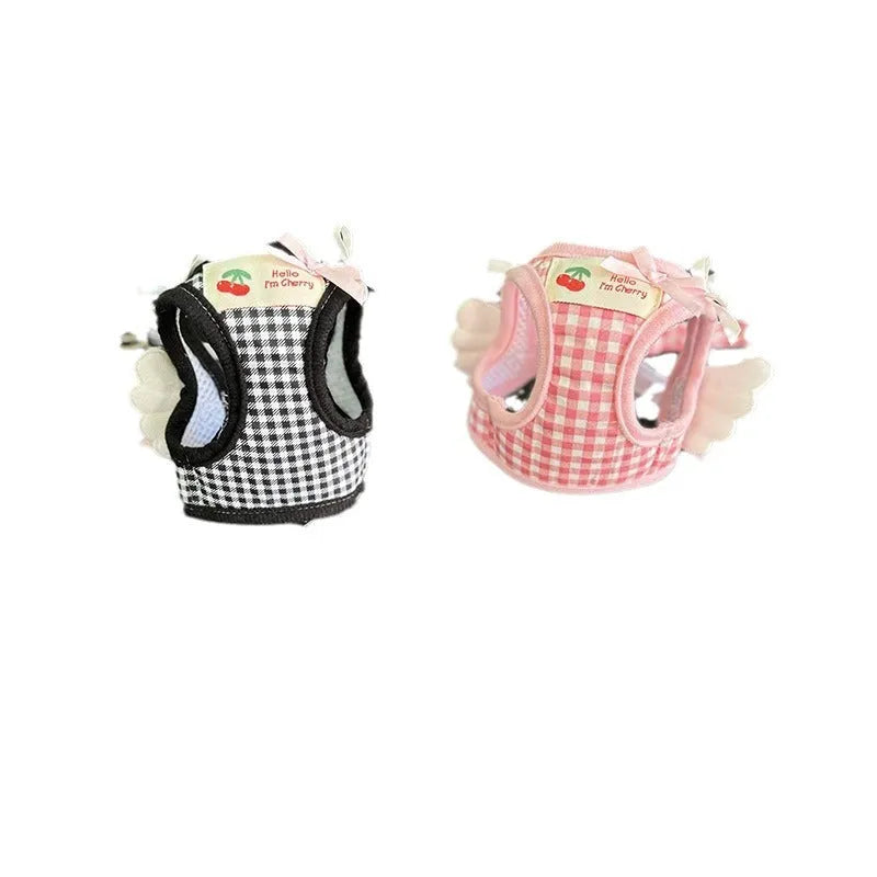 Pink cotton chest and back harness with hand-holding rope for a small dog on a white background.