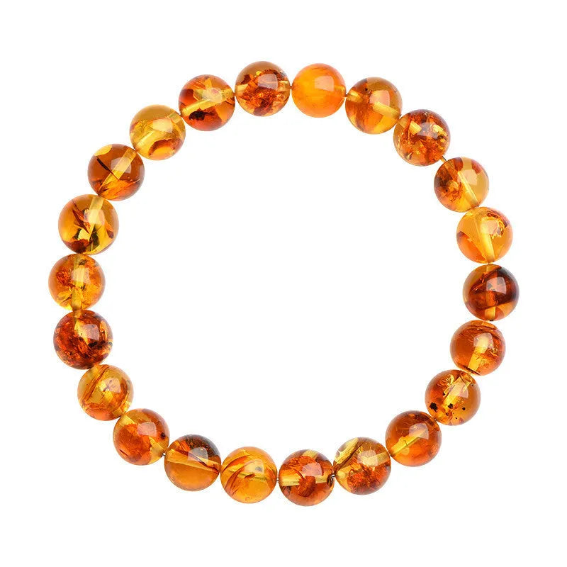 Natural yellow piebald amber bracelet with geometric design on a wrist.