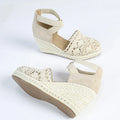 Women's apricot canvas Roman style wedge sandals with a round toe on a plain background.