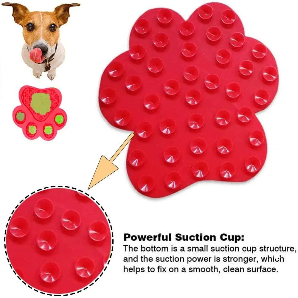 Blue bone-shaped silicone dog licking mat with suction cups on a tiled shower wall.