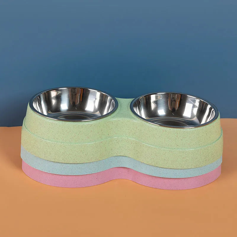 Double pet bowl set with two stainless steel bowls and blue straw holder on white background