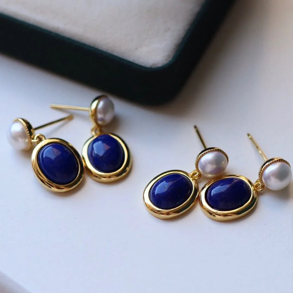 A pair of lapis lazuli pearl drop earrings on 925 silver posts with engraved patterns.