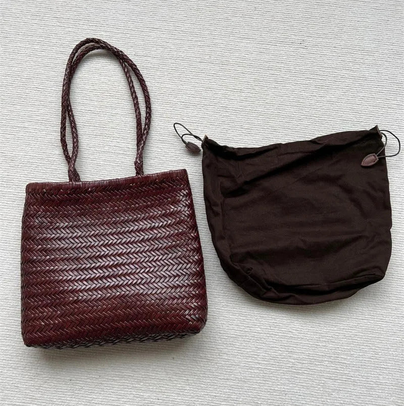 Brown handmade cowhide leather woven tote bag with a three-dimensional front pocket.