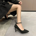 Women's black stiletto pumps with skull pattern and buckle detail on rubber sole