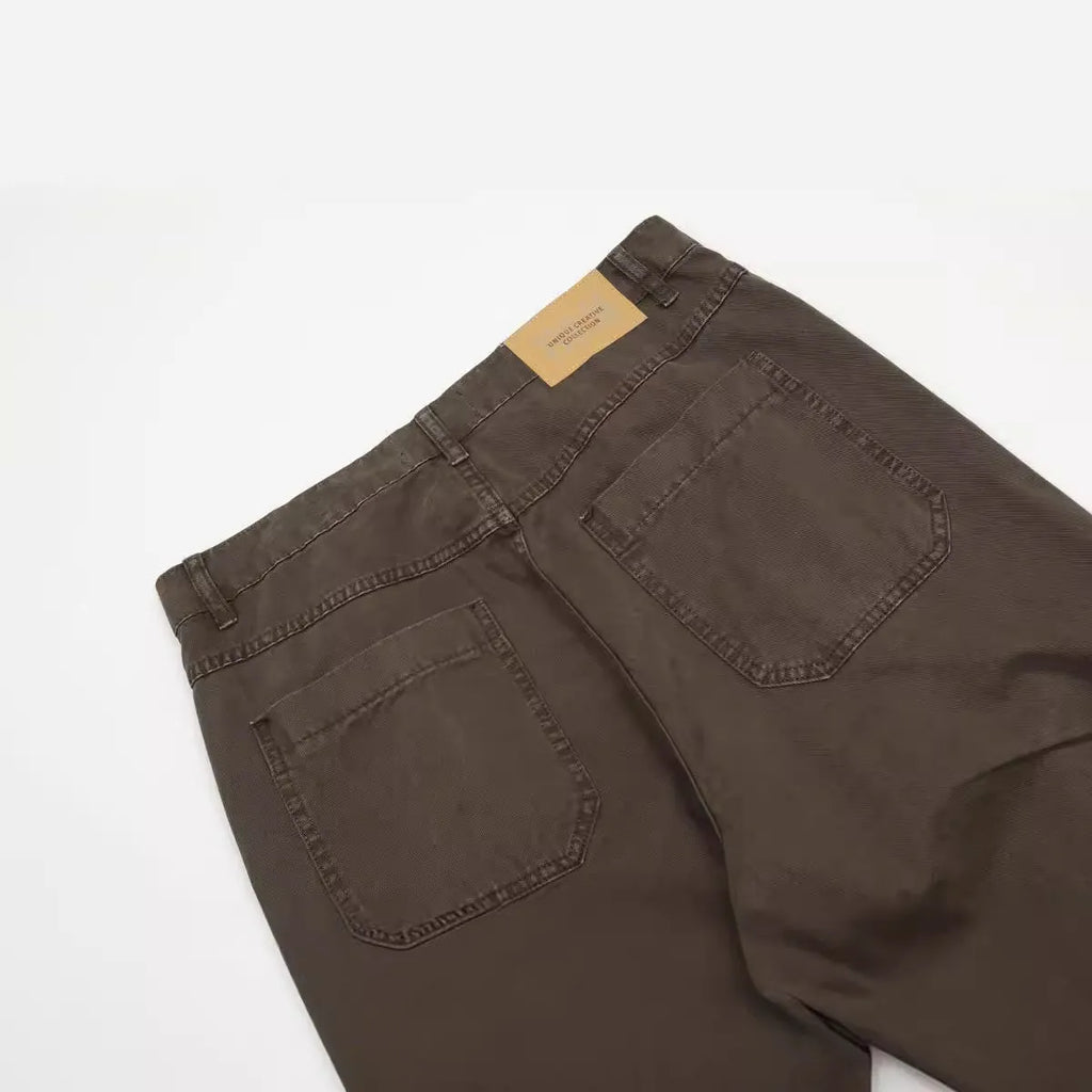 Men's brown loose-fit straight leg trousers with a high waist and wide-leg style on a hanger.