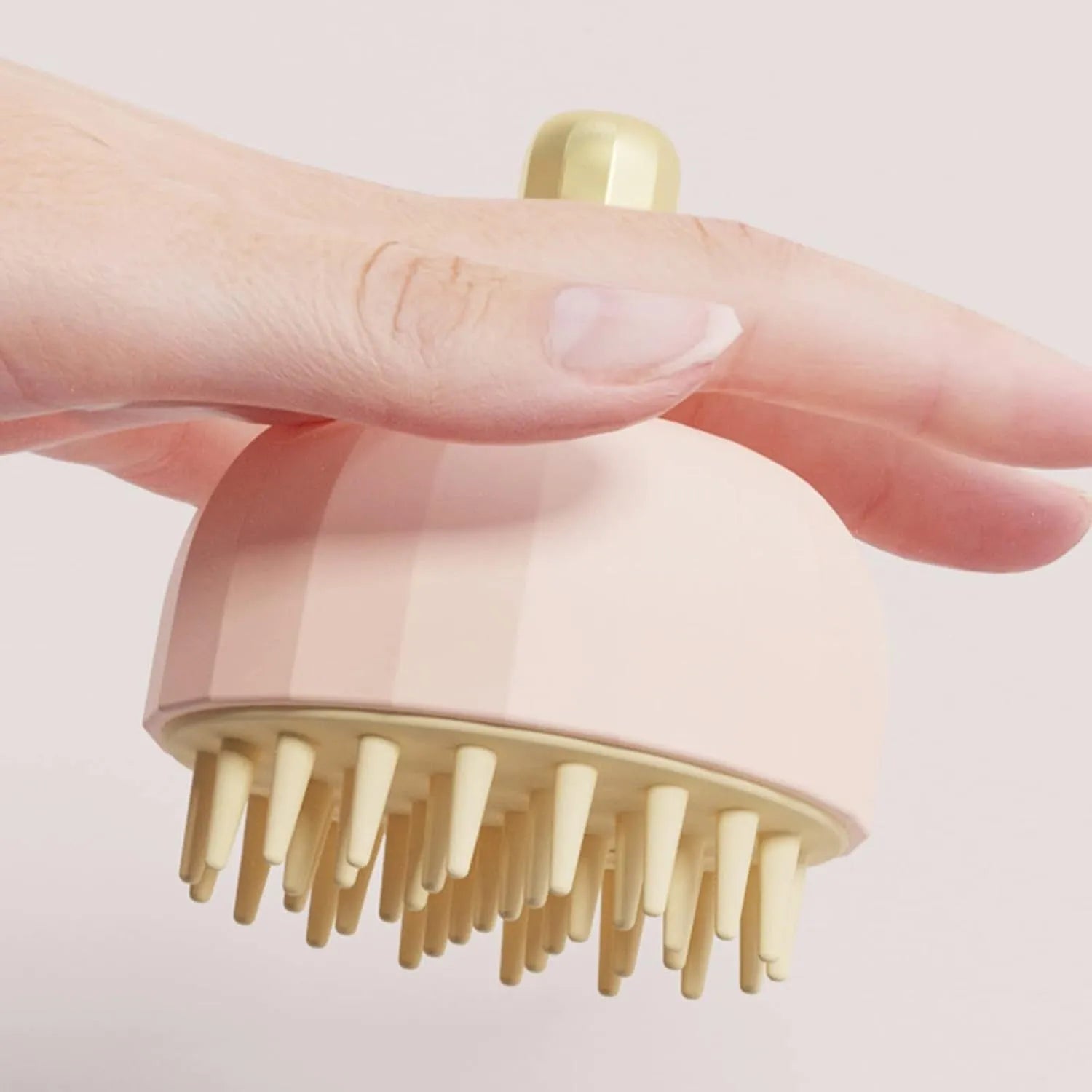 Green double-sided silicone pet bath massage brush with drain holes on a white background.