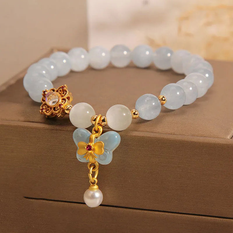 Women's aquamarine butterfly pendant crystal bracelet with rhinestone detailing on adjustable chain