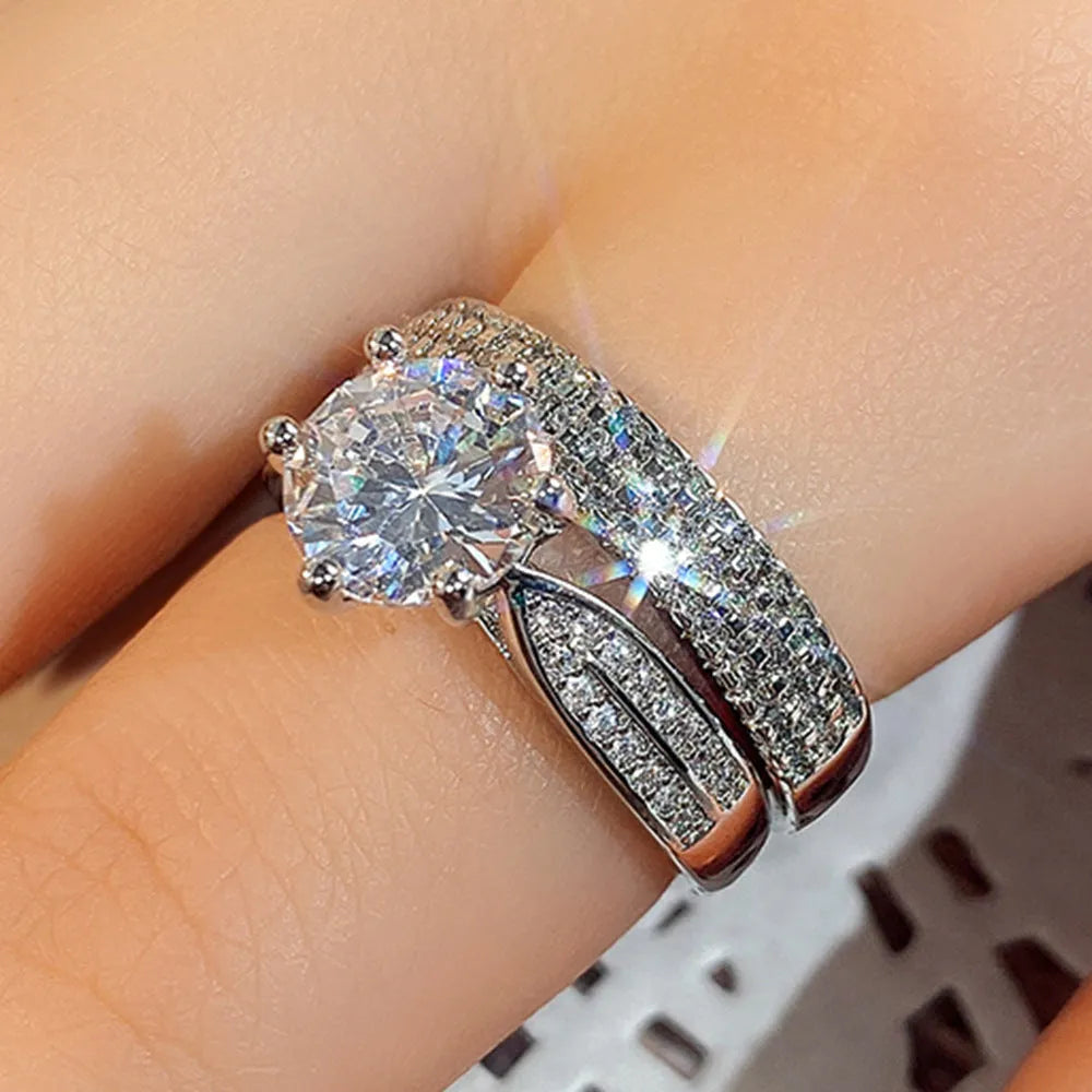 White gold alloy combined ring bracelet with round geometry design on finger.