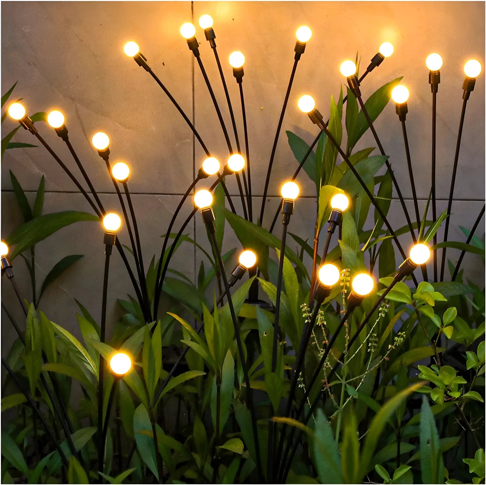 Solar-powered LED garden stake light with automatic sensor, shown pushed into soil beside plants.