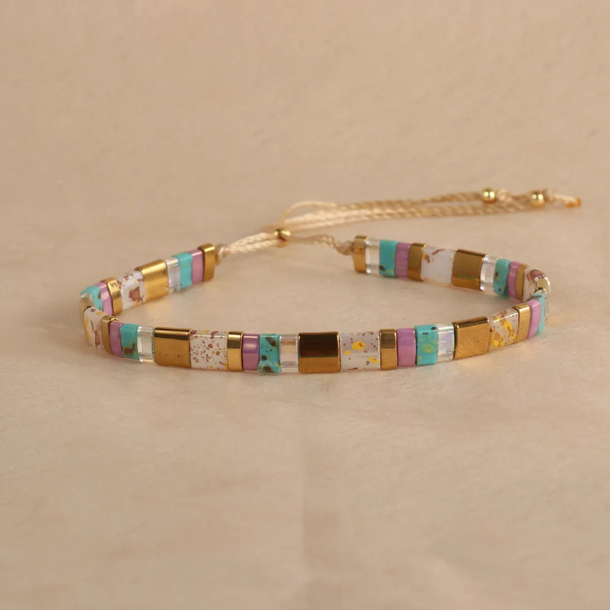 Geometric beaded bracelet with round glass and coloured glaze beads in five colour options.