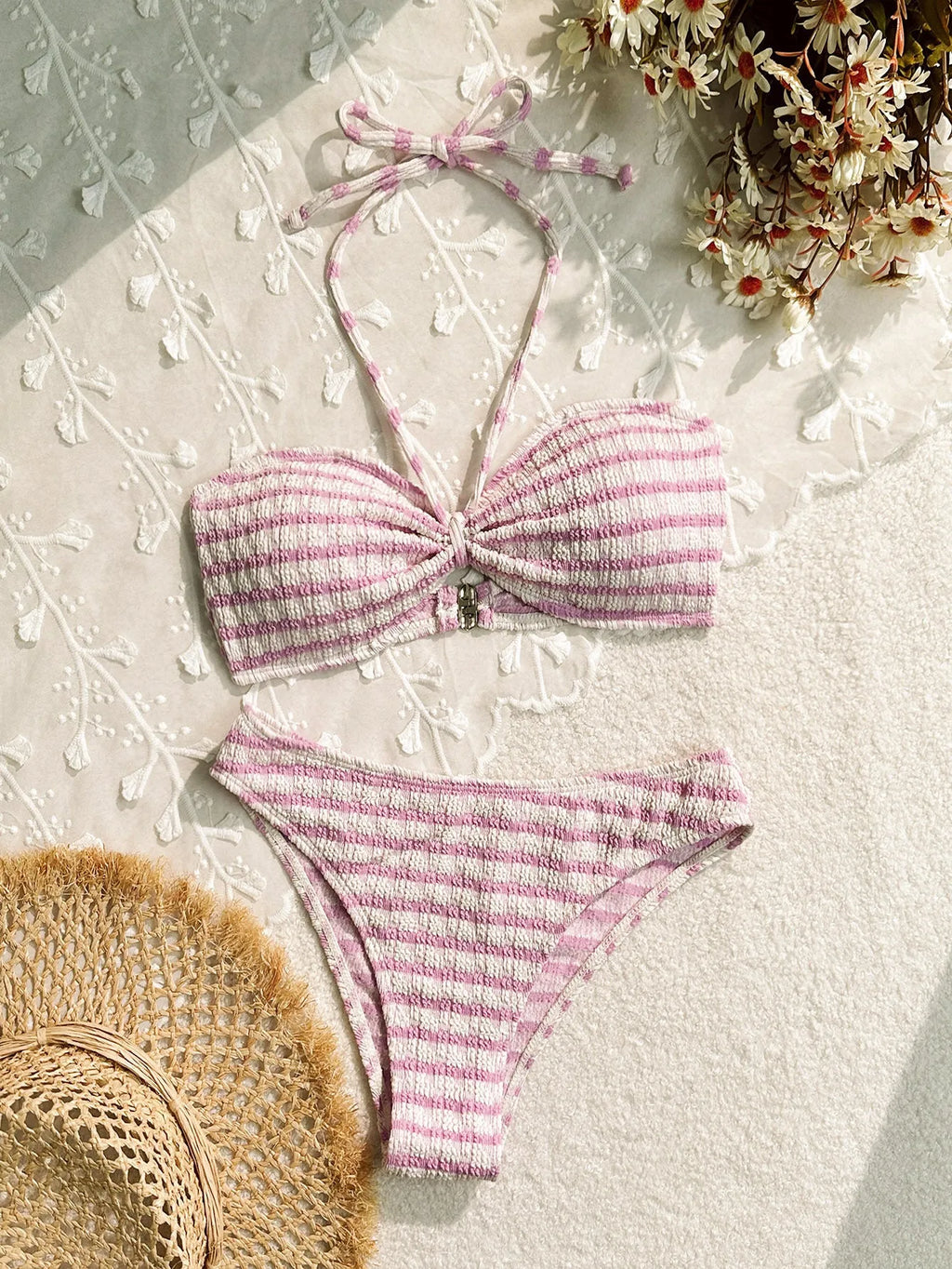 Women's pink and black striped bikini swimsuit top and briefs on a mannequin