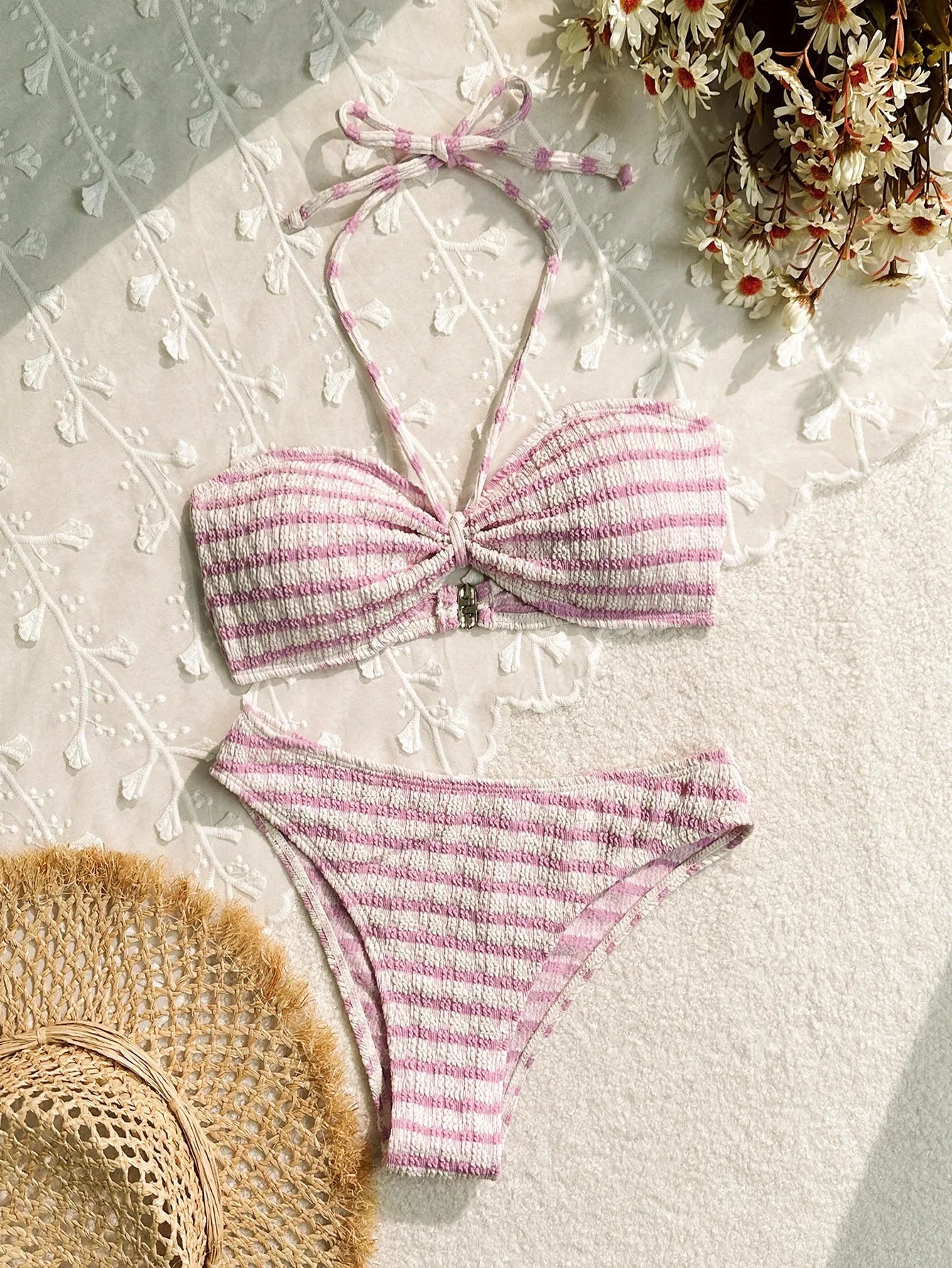 Women's pink and black striped bikini swimsuit top and briefs on a mannequin