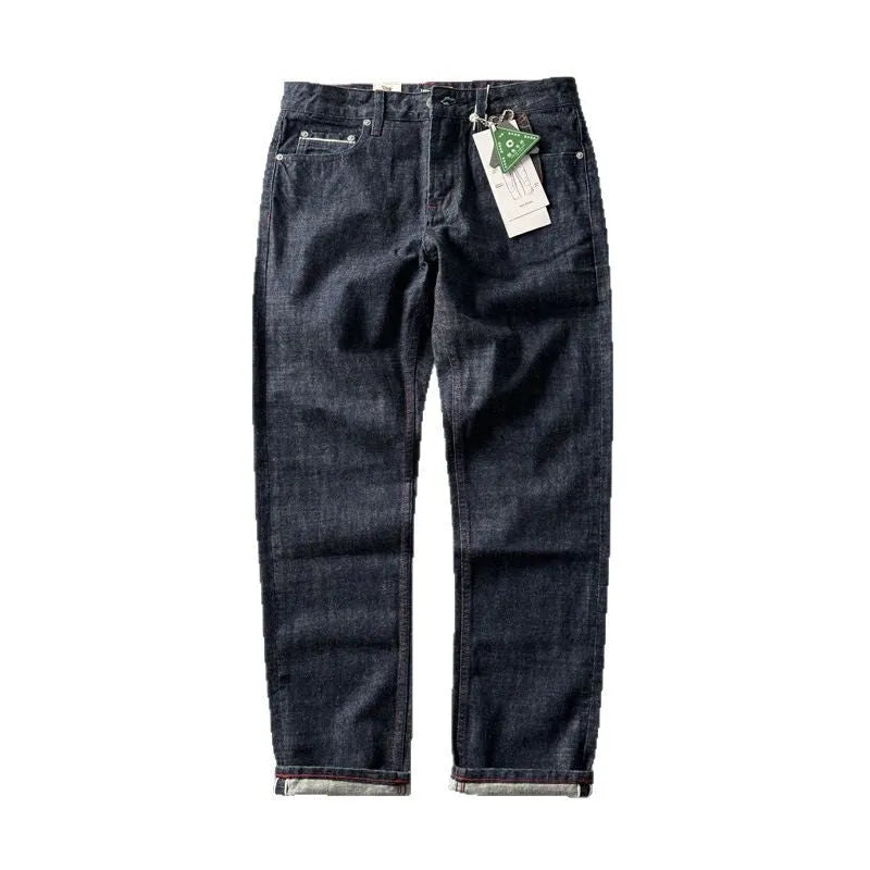Man wearing blue straight leg denim jeans with a mid waist, showcasing the classic five-pocket retro design.