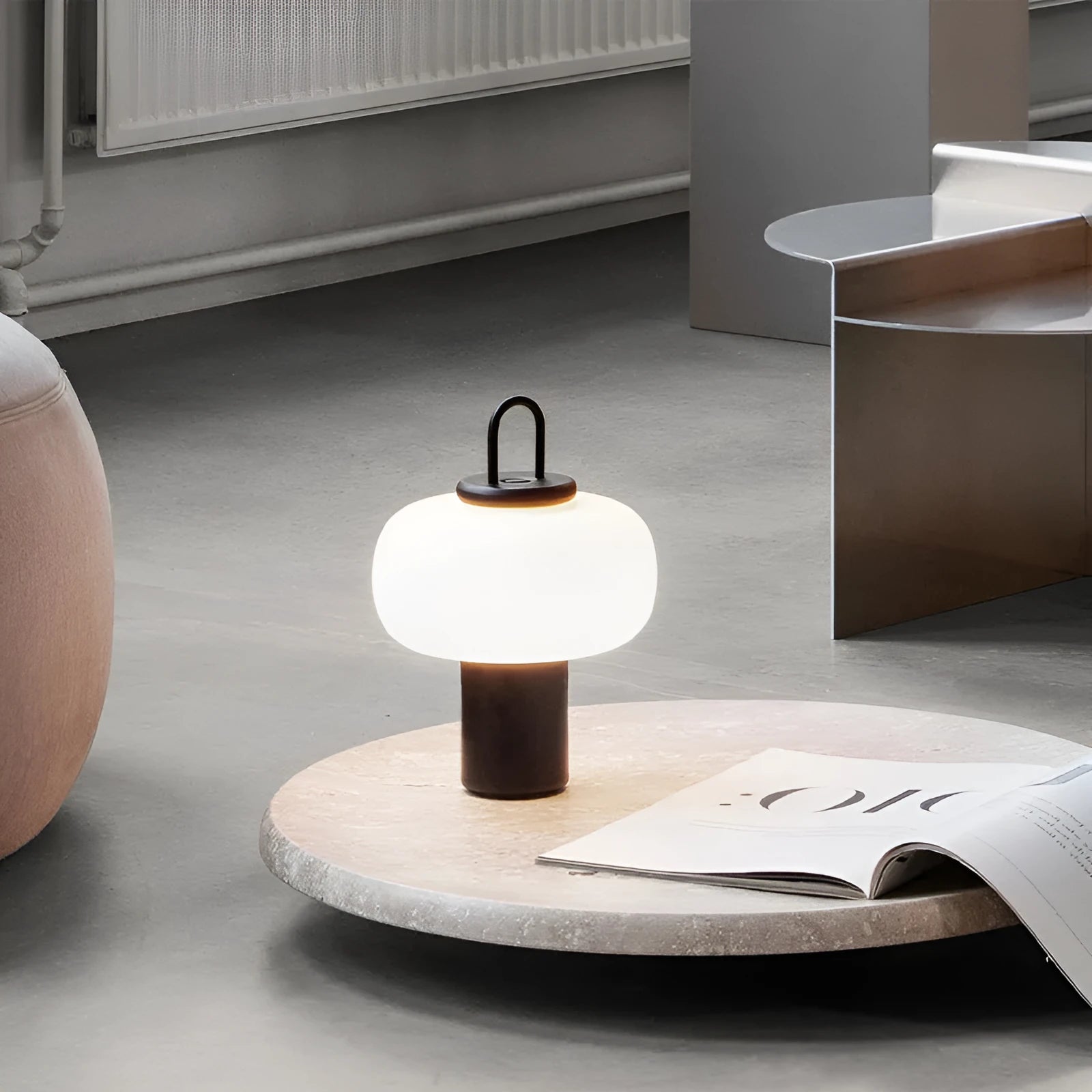Minimalist Japanese glass bedside table lamp with warm light for a child's bedroom.