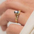 Gold plated floral ring with green zircon stone inlay on a hand, showing side profile and detail.