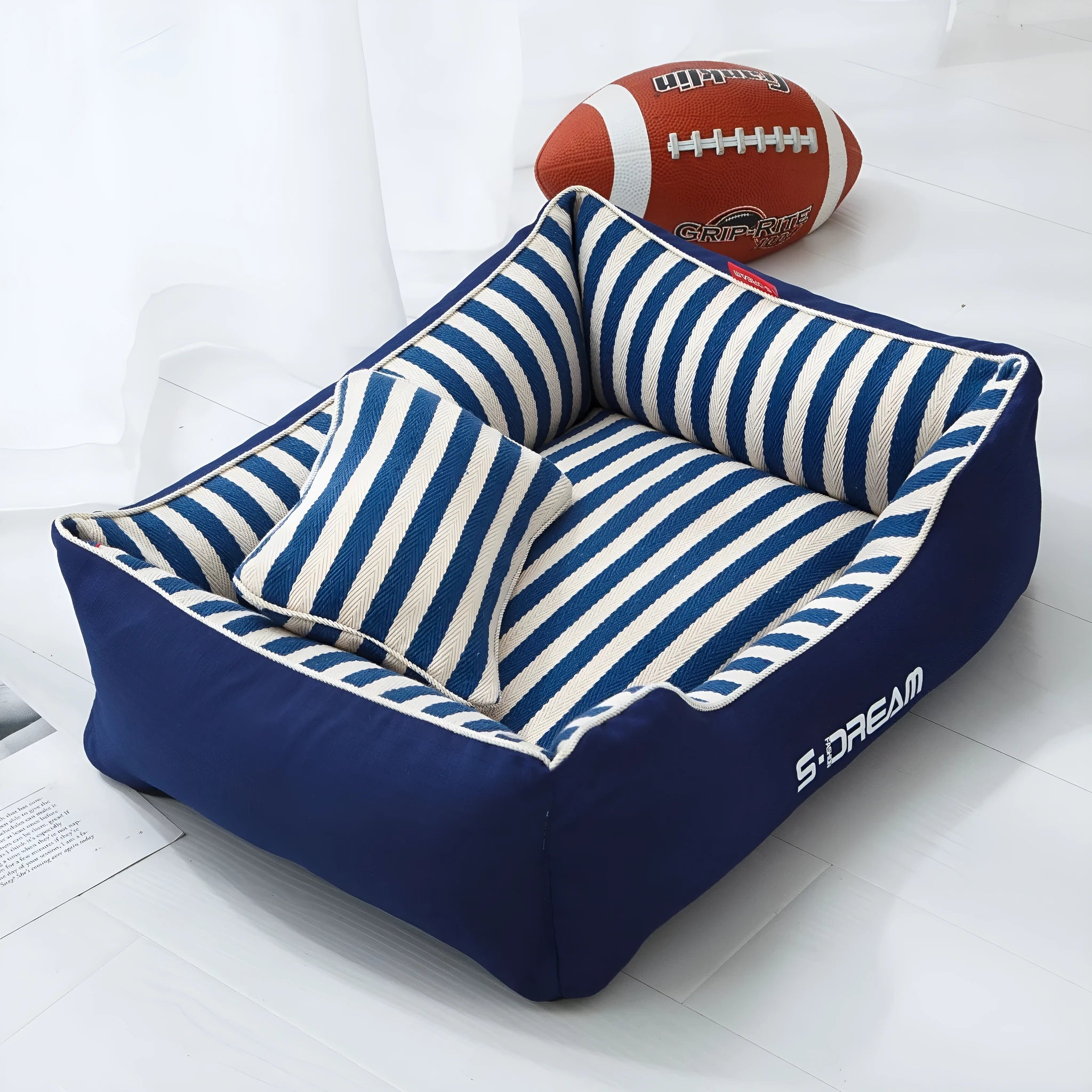 Navy stripes washable dog kennel mat with removable cover and a blue mini pillow, shown in an L size.