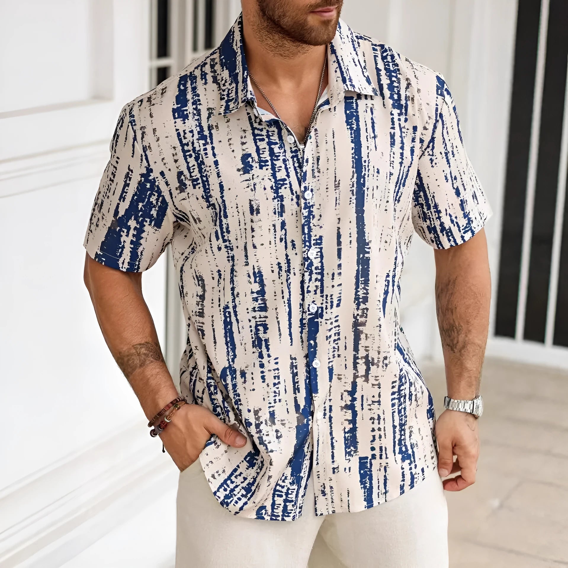 Man wearing a striped short sleeve casual shirt in a light colour, showcasing the 3D print detail.