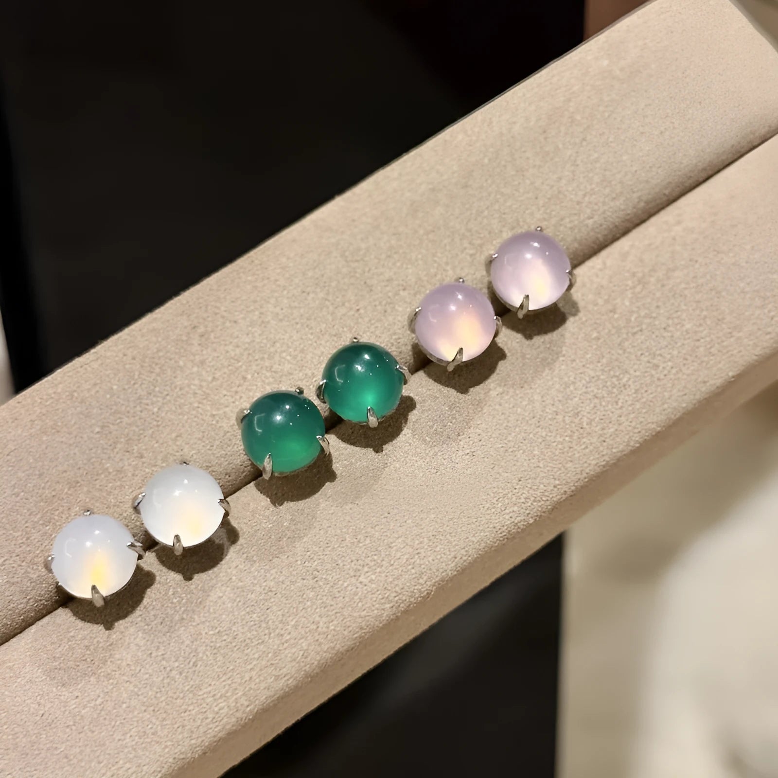 Chalcedony stud earrings with round egg surface design and four-claw settings in copper