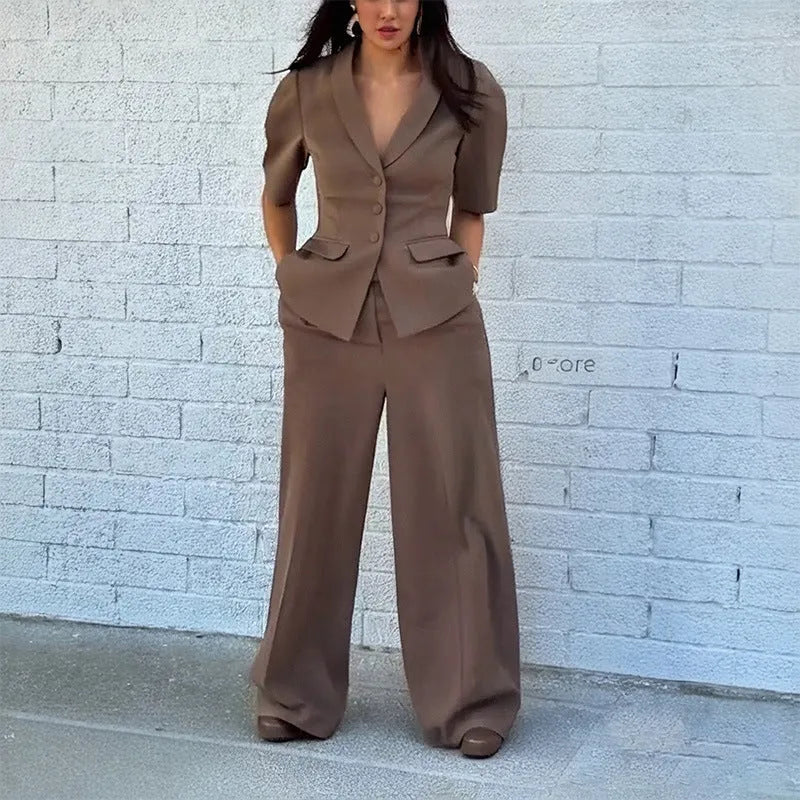 Brown men's slim fit polyester suit with long sleeve top and full length trousers on a hanger