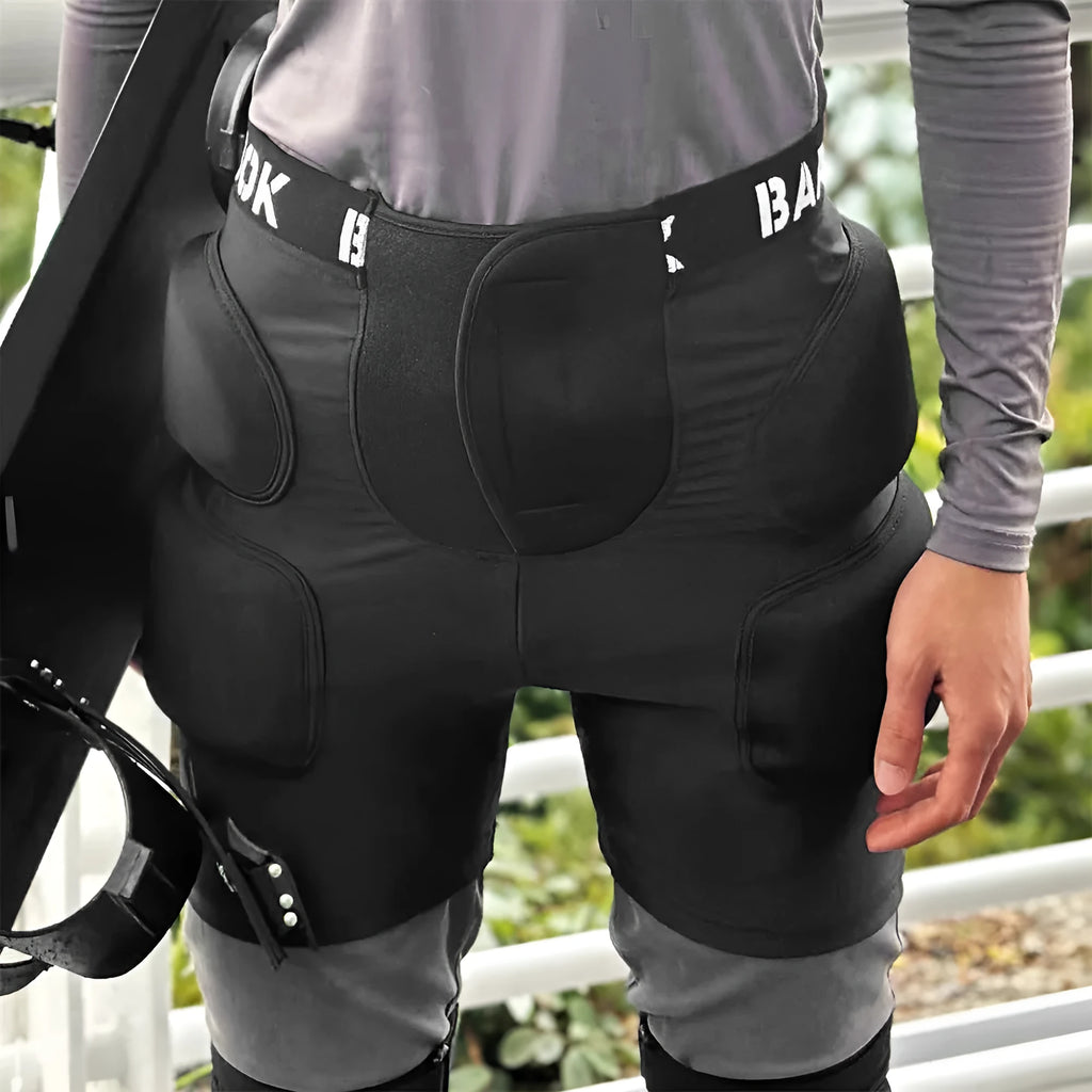 Black adult skating hip protection pad made of spandex and NBR foam on a grey background.