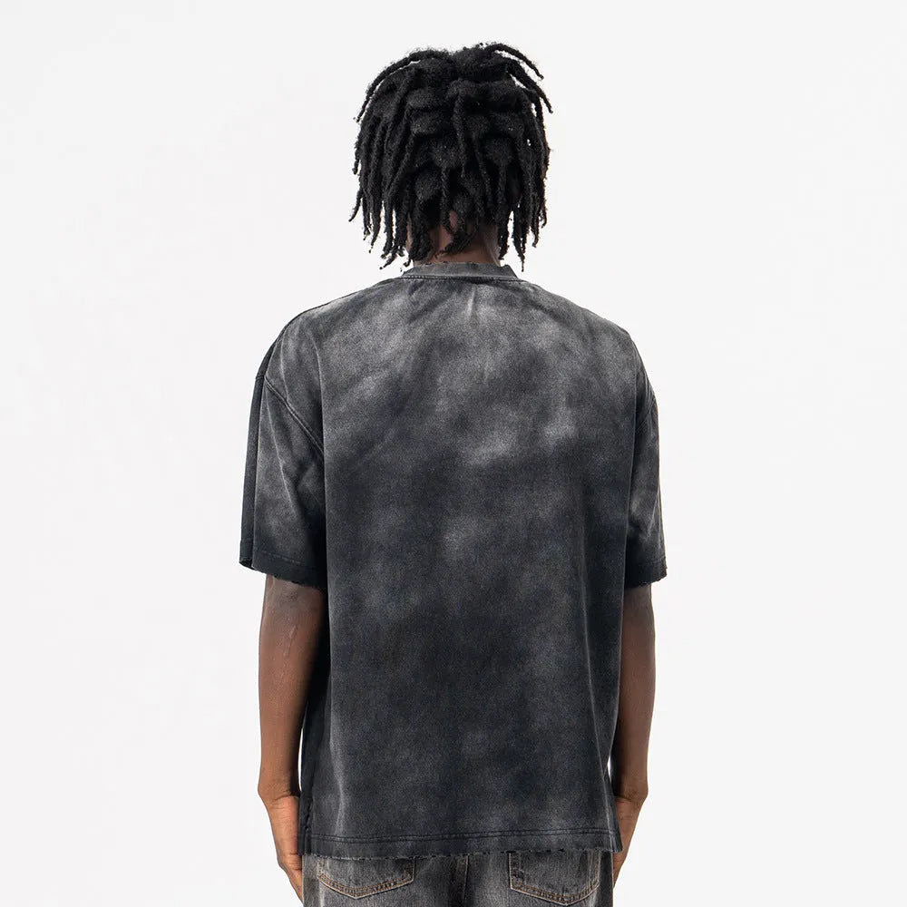 Black loose-fit men's cotton t-shirt with drop-shoulder sleeves on a grey background.