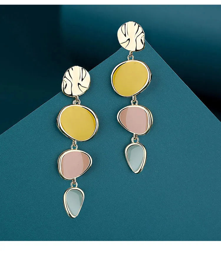 A pair of simple disc-shaped earrings with a blended Morandi colour finish on a sterling silver post.