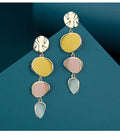 A pair of simple disc-shaped earrings with a blended Morandi colour finish on a sterling silver post.