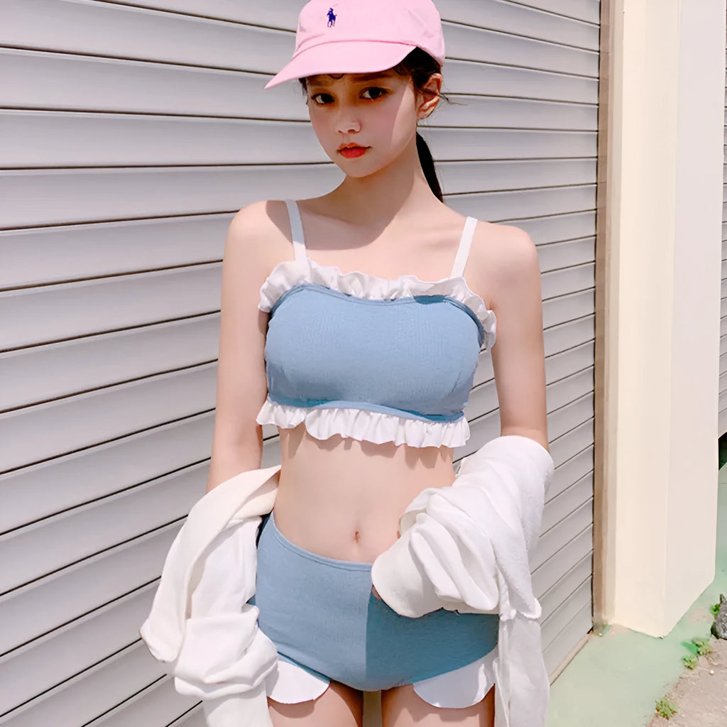 Solid colour conservative one-piece swimsuit for women with suspender straps.