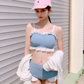 Solid colour conservative one-piece swimsuit for women with suspender straps.