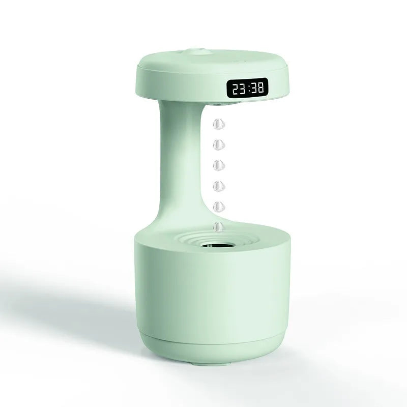 White anti-gravity humidifier showing water droplets levitating upwards from its mist outlet.