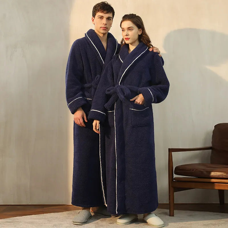 A man and woman wearing matching thick navy blue flannel bathrobes, ankle-length winter nightgown style.