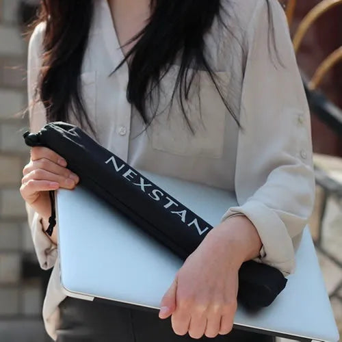 Black foldable portable laptop stand shown with its nylon carry bag and gaskets