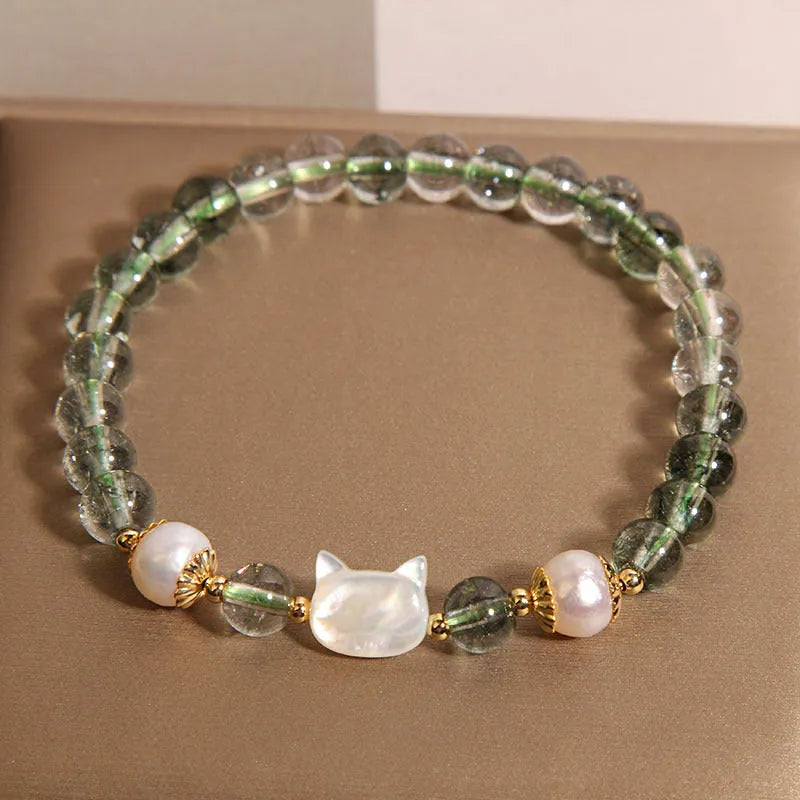 Green Phantom Quartz crystal bracelet with a detailed Shell Kitten charm on a women's wrist.