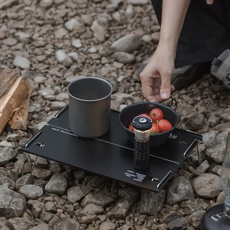 Outdoor 05 Series aluminium alloy folding table shown folded and unfolded in black and grey colours.