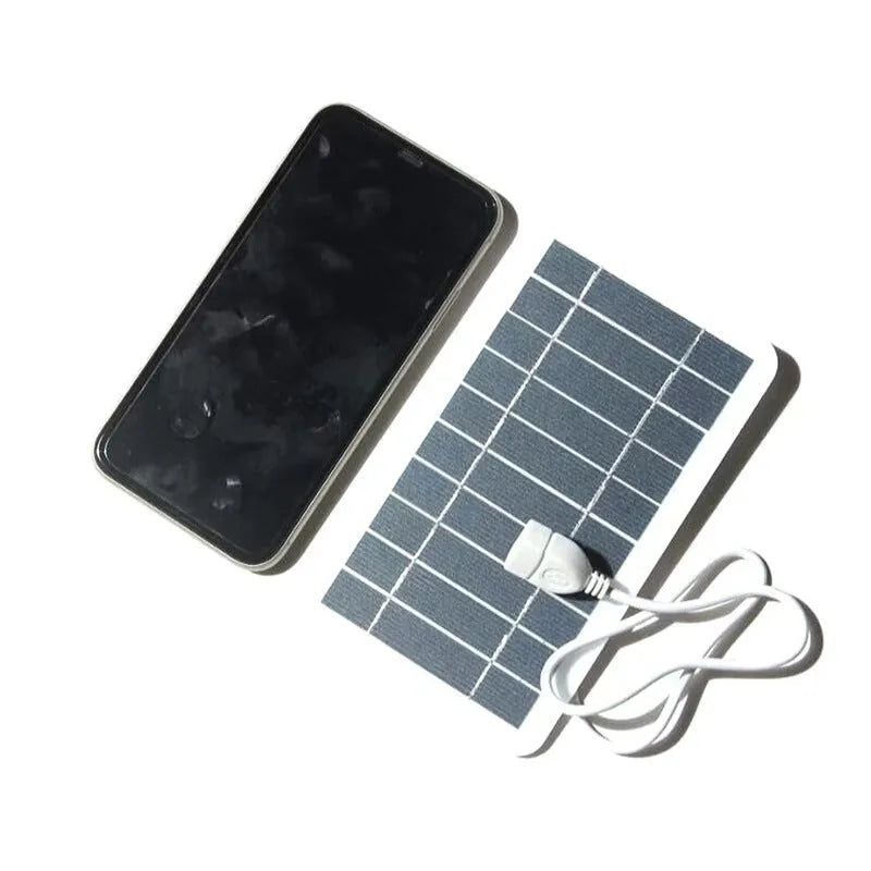Portable solar panel charger measuring 157x94mm with USB cable for mobile device charging