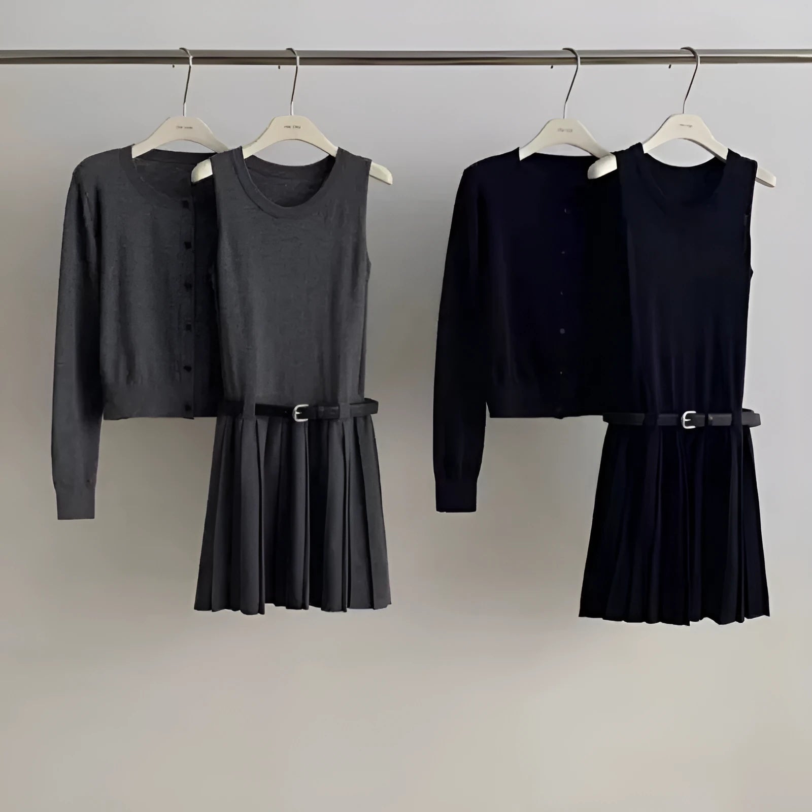 Women's grey knitted vest skirt and long-sleeve cardigan set with 3D pattern and an adjustable waist belt.