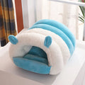 Closed cat nest bed in blue, shown with soft internal pad, illustrating its enclosed design for cats.