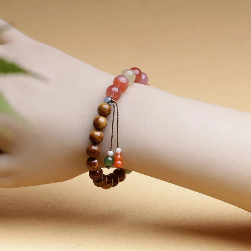 8mm persimmon orange agate bracelet with diamond-shaped beads on wrist