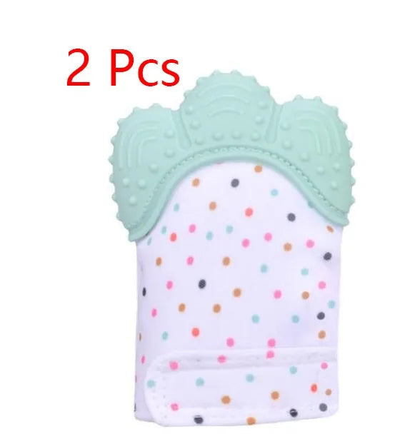 BPA-free silicone baby teether glove fastened with a white Velcro strap on a baby's hand