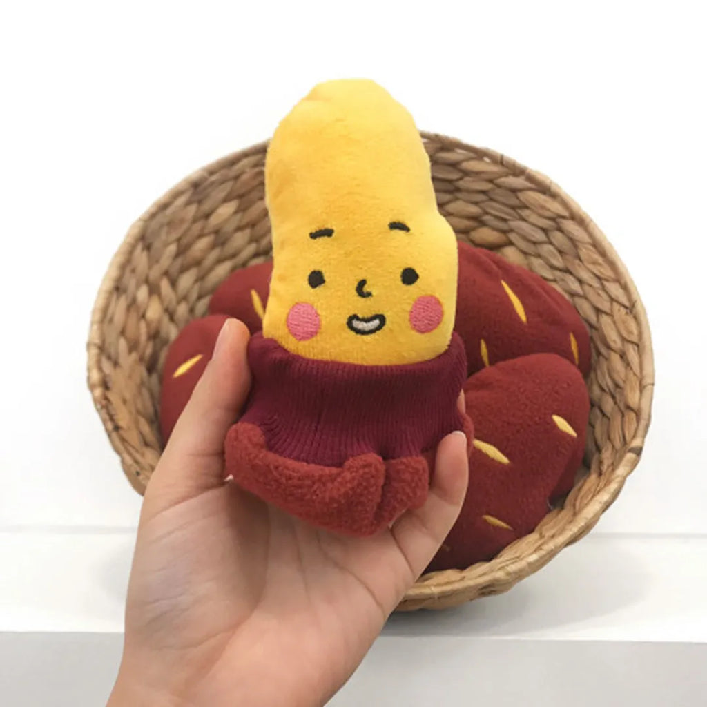 Red sweet potato pet toy with peelable exterior revealing hidden food pocket for treat dispensing