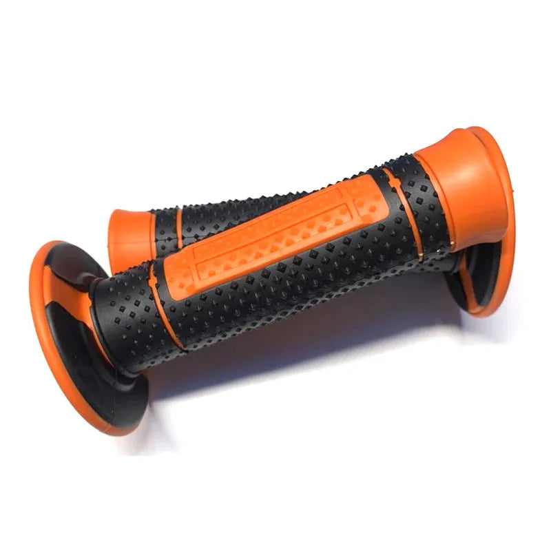 Pair of black and orange rubber motorcycle handle covers for KTM off-road bikes, shown on handlebars