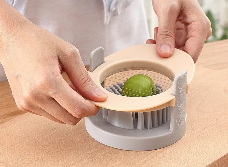 Manual three-in-one egg cutter in blue, orange and red with stainless steel blades and stackable design