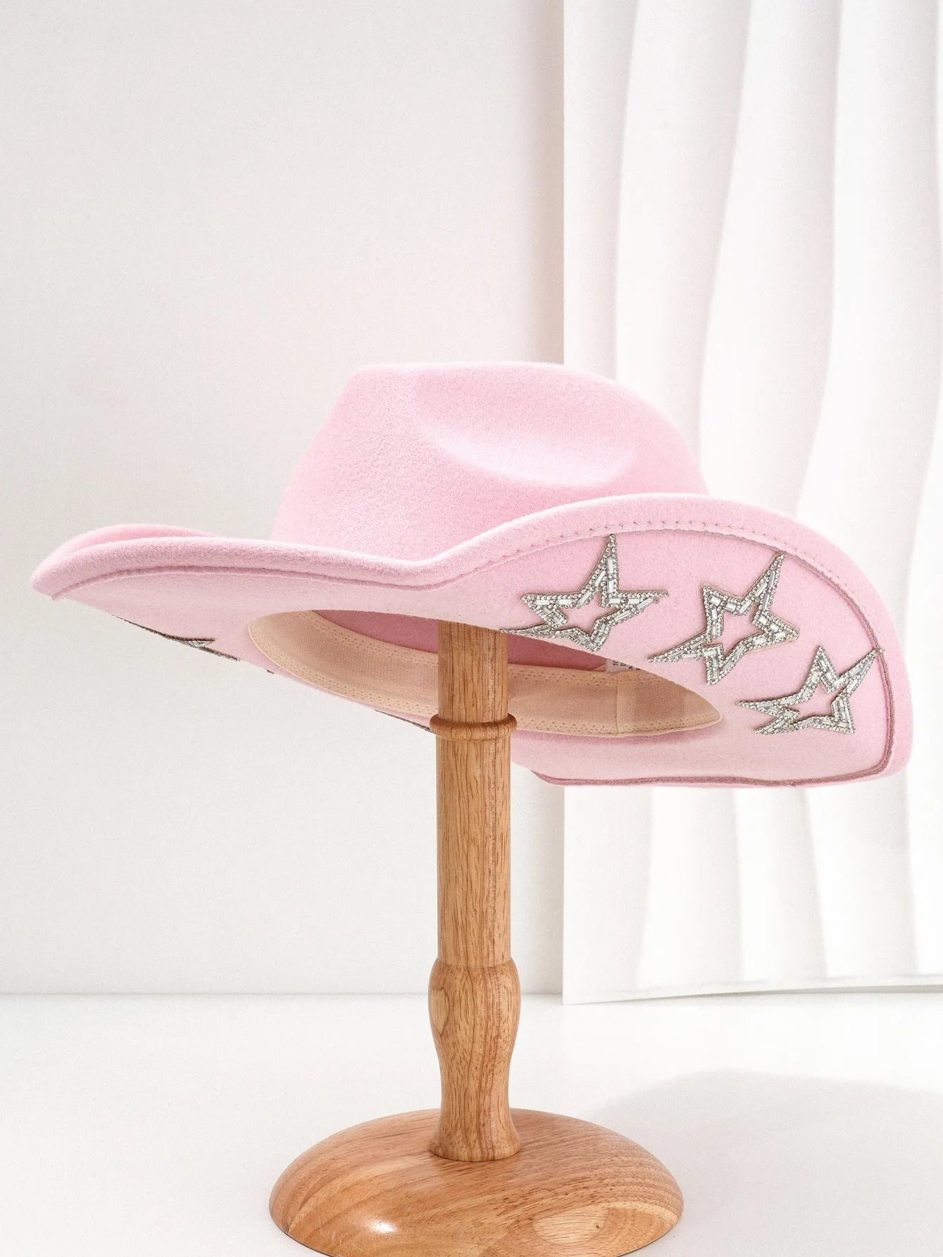 Beige wool felt western cowboy hat with a hexagonal star on the side, conical crown.