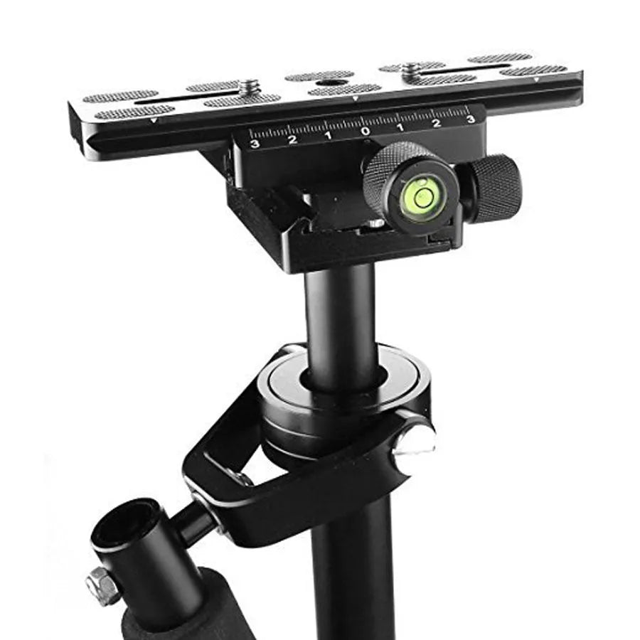 Black aluminium handheld camera stabiliser with adjustable height on a table.