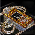 Perfume bottle bow design iPhone case with textured TPU silicone and a fixed metal chain, shown in black, gold, pink, and transparent.