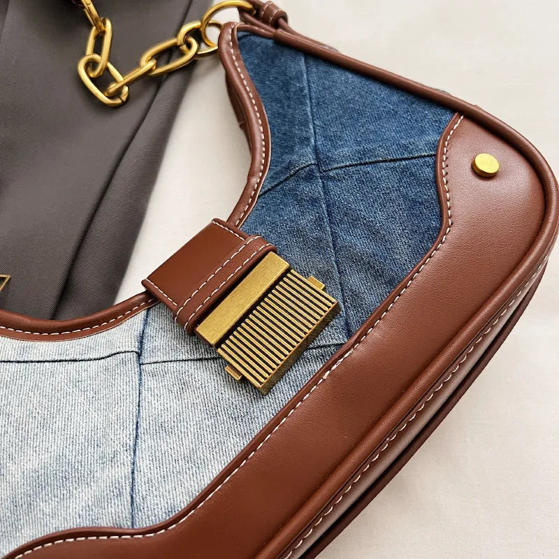Brown denim women's bucket shoulder bag with diamond mesh detail and a chain strap.