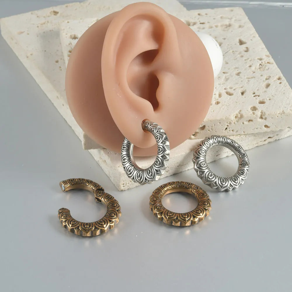 Retro geometric dragon-shaped hollow out earrings in antique silver finish, shown from the front.