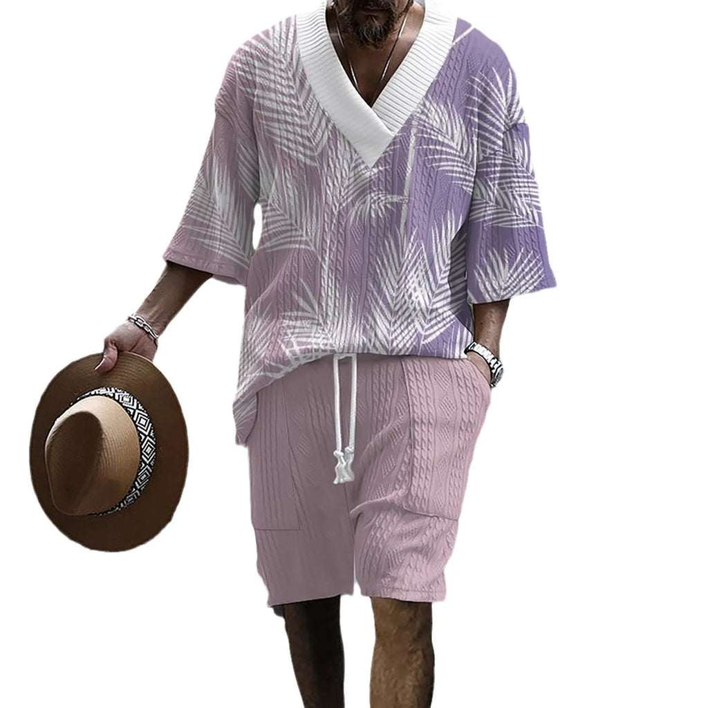 Man modelling a printed drop-shoulder knitted short-sleeved top with matching shorts in a casual setting.